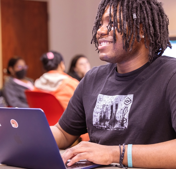 Student in business class with laptop