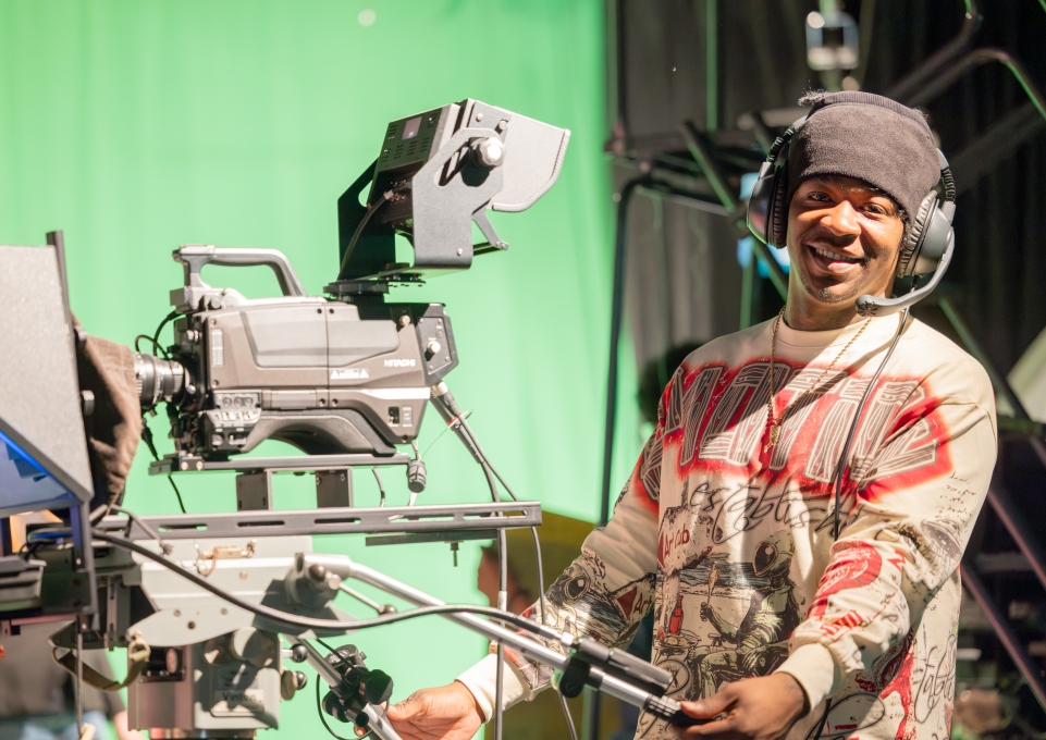 Male student uses video equipment